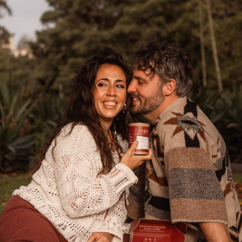 Couple enjoying a picnic under a tree in a park
